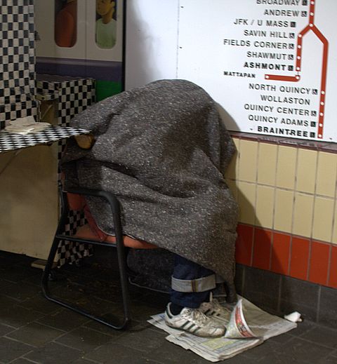 Sleeping upright on the main landing of the Harvard Square T station