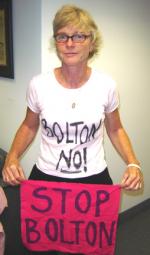 Gael Murphy of Code Pink with BOLTON NO! tee shirt and STOP BOLTON sign.