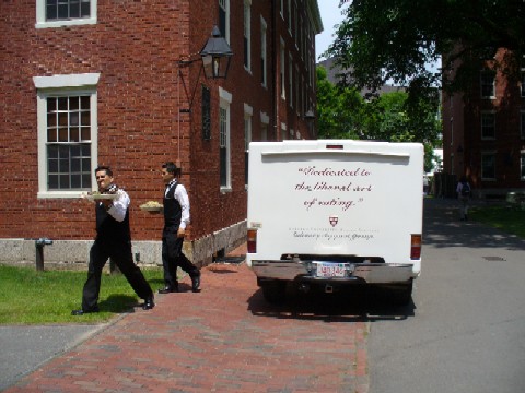 Two waitrons and the Harvard University Dining Services Culinary Support Group Truck