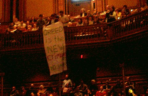 Students Labor Action Movement drop 'Greed is the New Crimson' Banner.