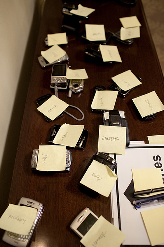 Members of Congress leave phones outside a White House meeting